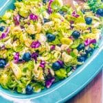 A close up picture of the finished Brussels Sprout Salad in a blue bowl.