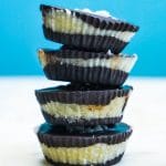 A stack of four coconut butter cups on top of each other.