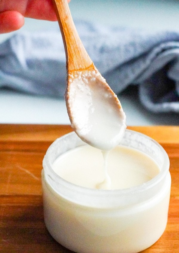 A spoon dipping into a jar of homemade Coconut Butter.
