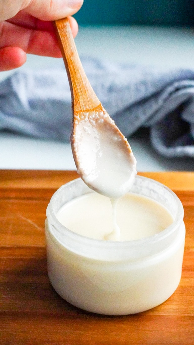 A spoon dipping into a jar of homemade Coconut Butter.
