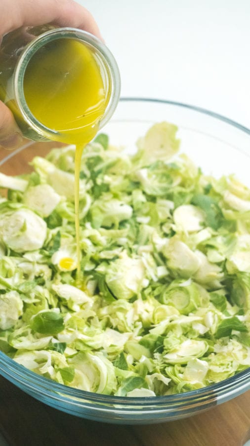 lemon poppy seed dressing poured over brussel sprout salad