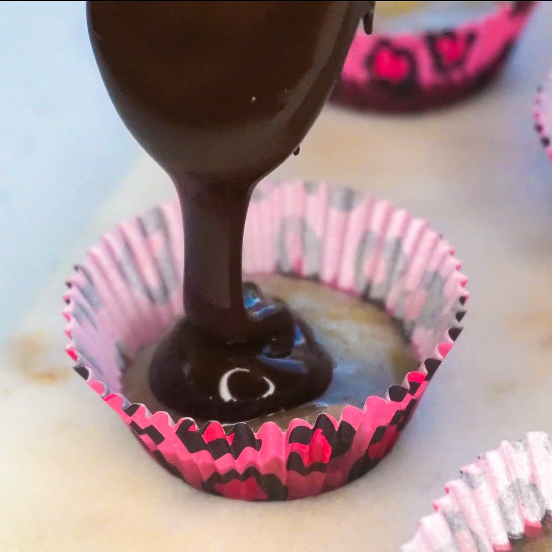 A picture showing how to make coconut butter cups.