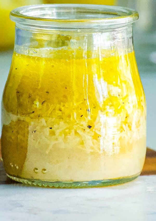 A close up picture of the finished Parmesan Dressing recipe in a glass jar.