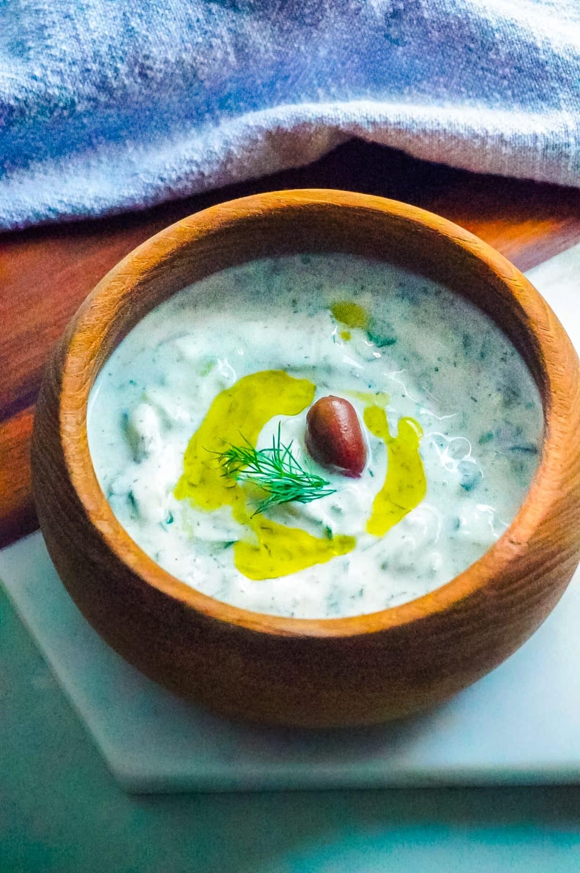 The finished Tzatziki Sauce in a wooden serving bowl. 