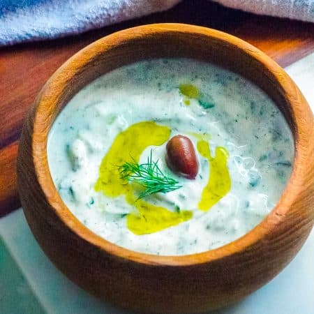 The finished Tzatziki Sauce in a wooden serving bowl.