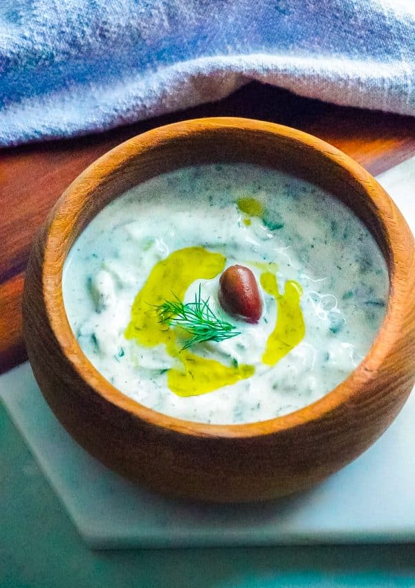 The finished Tzatziki Sauce in a wooden serving bowl.
