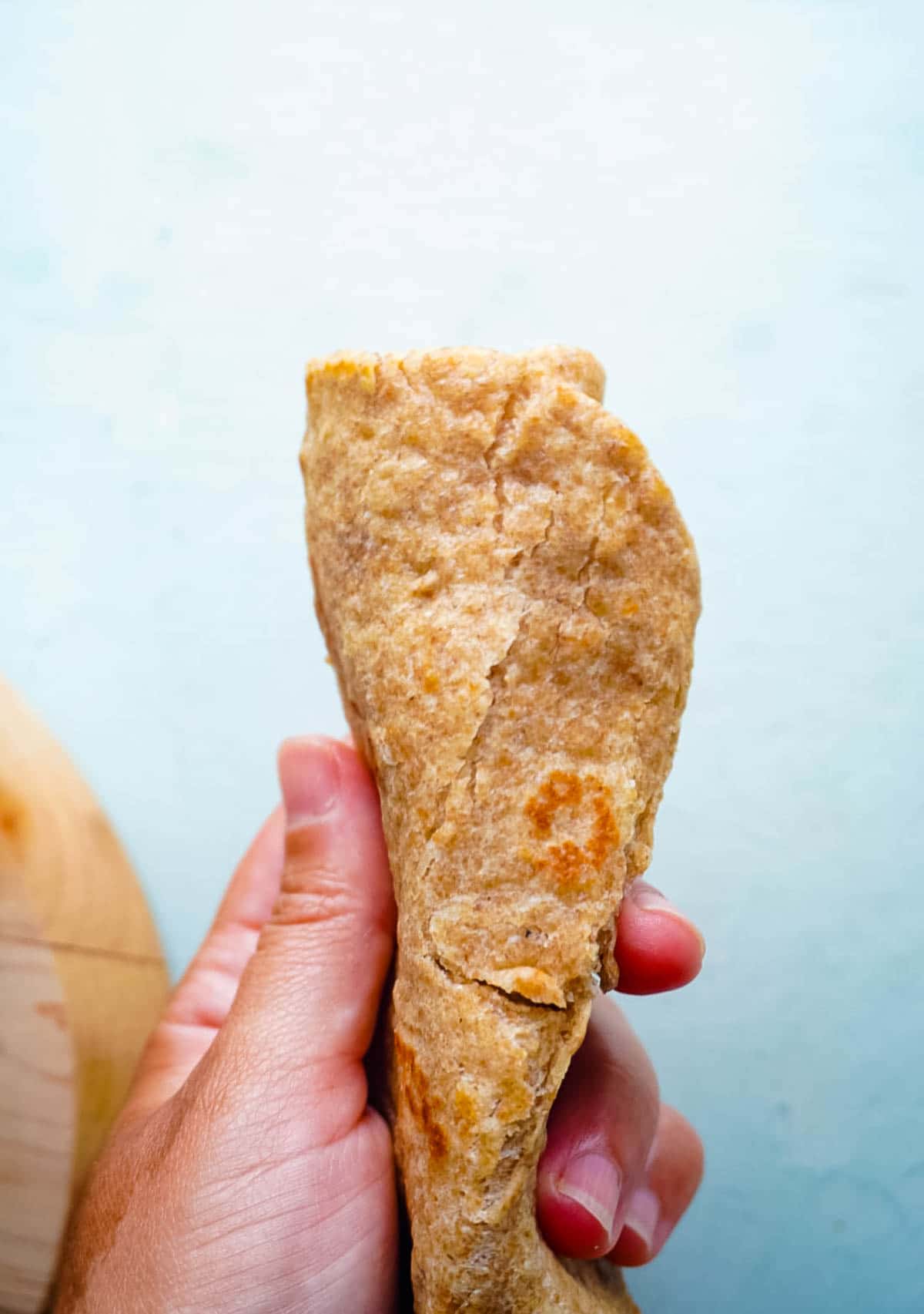 A tortilla cooked on too high of heat so it is cracked. 