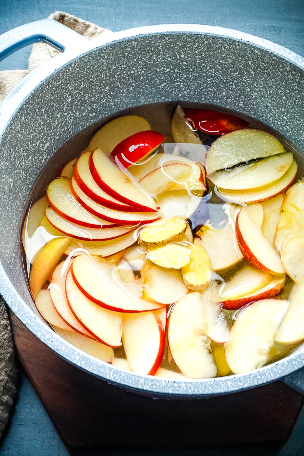 All od the ingredients of this Apple Cinnamon Tea recipe in a pot ready to simmer on the stove top.