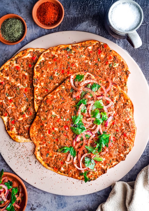 An overhead picture of three Lahmacun Turkish Pizzas.