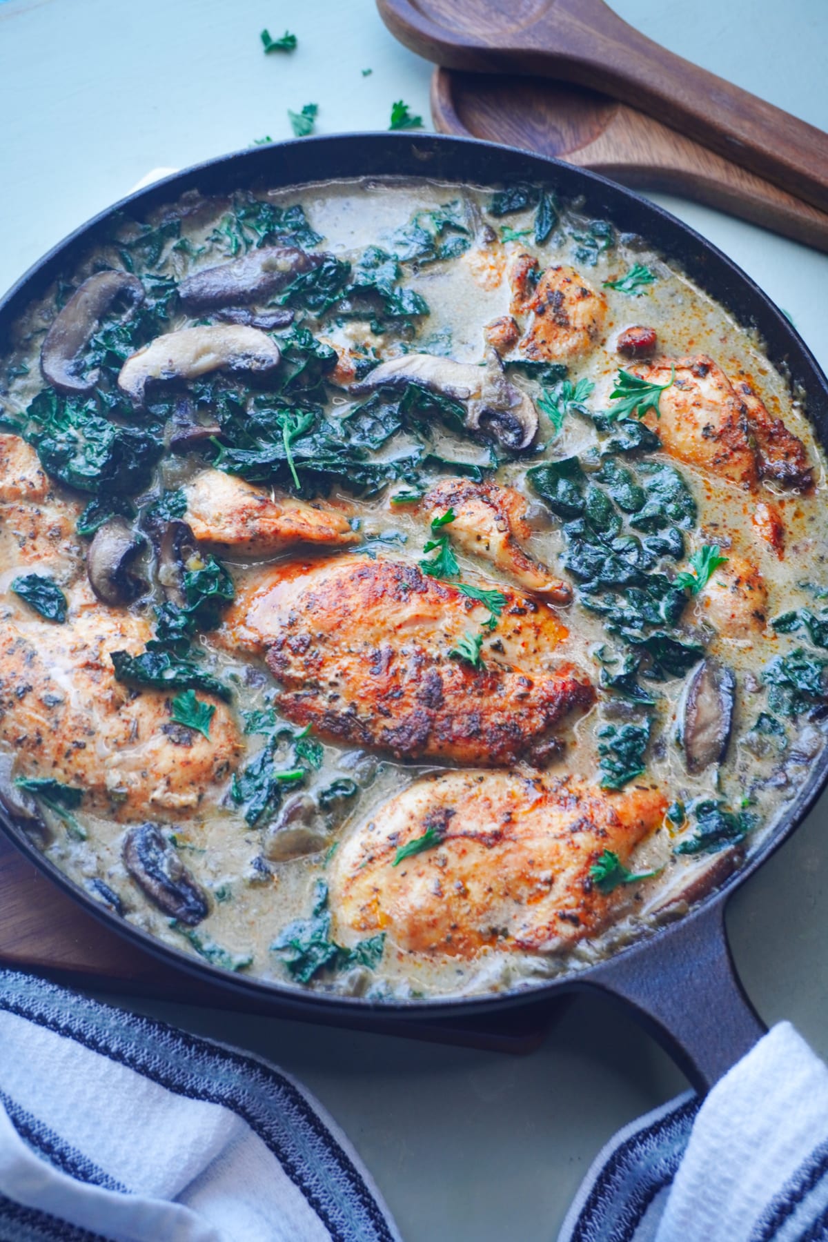 Creamy Crimini Tuscan Chicken with Kale (without cream) in a cast-iron pan