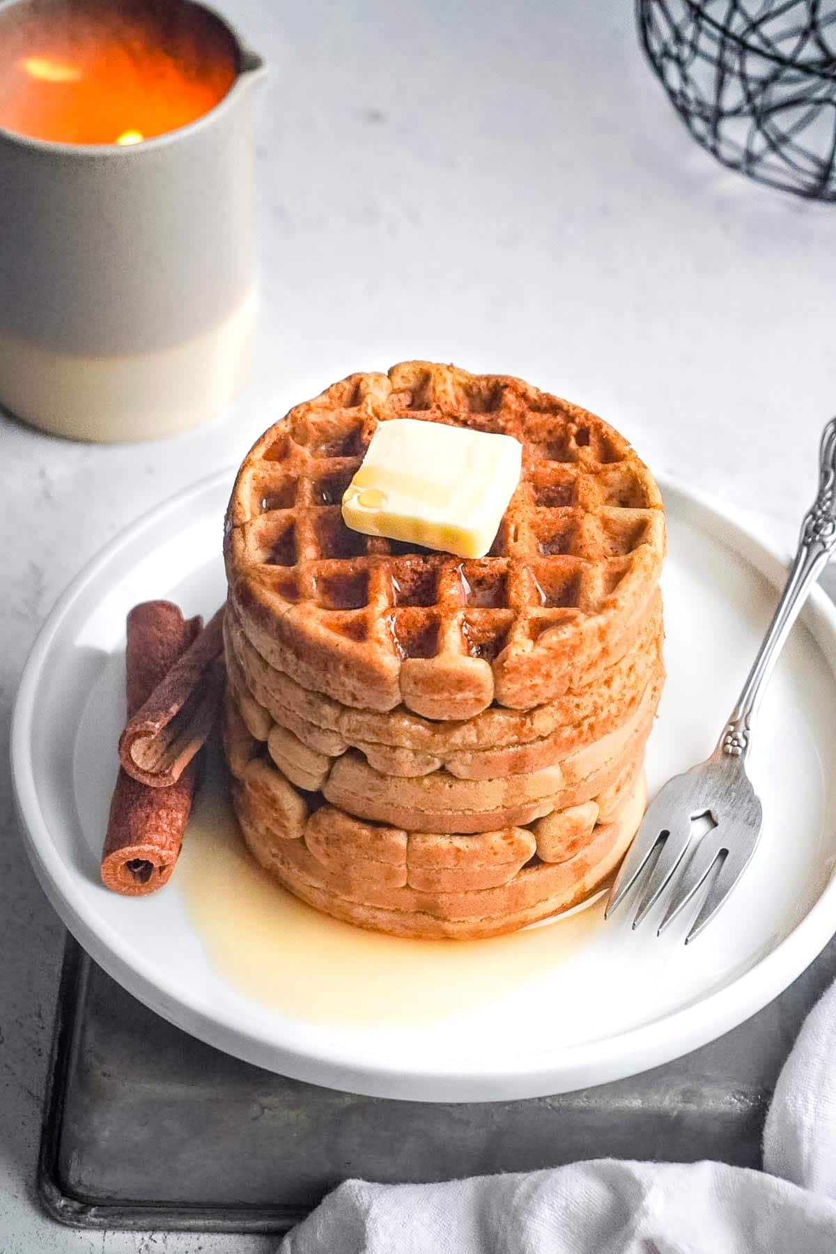 A stack of Gluten Free Waffles with a slab of coconut butter on top.