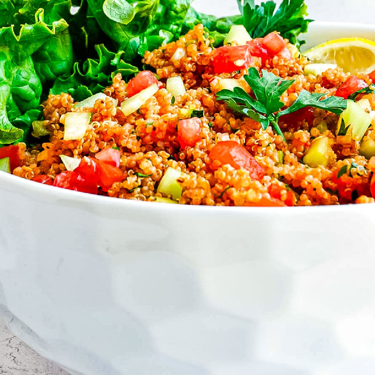 A close up picture of the finished kisir recipe in a white serving bowl.