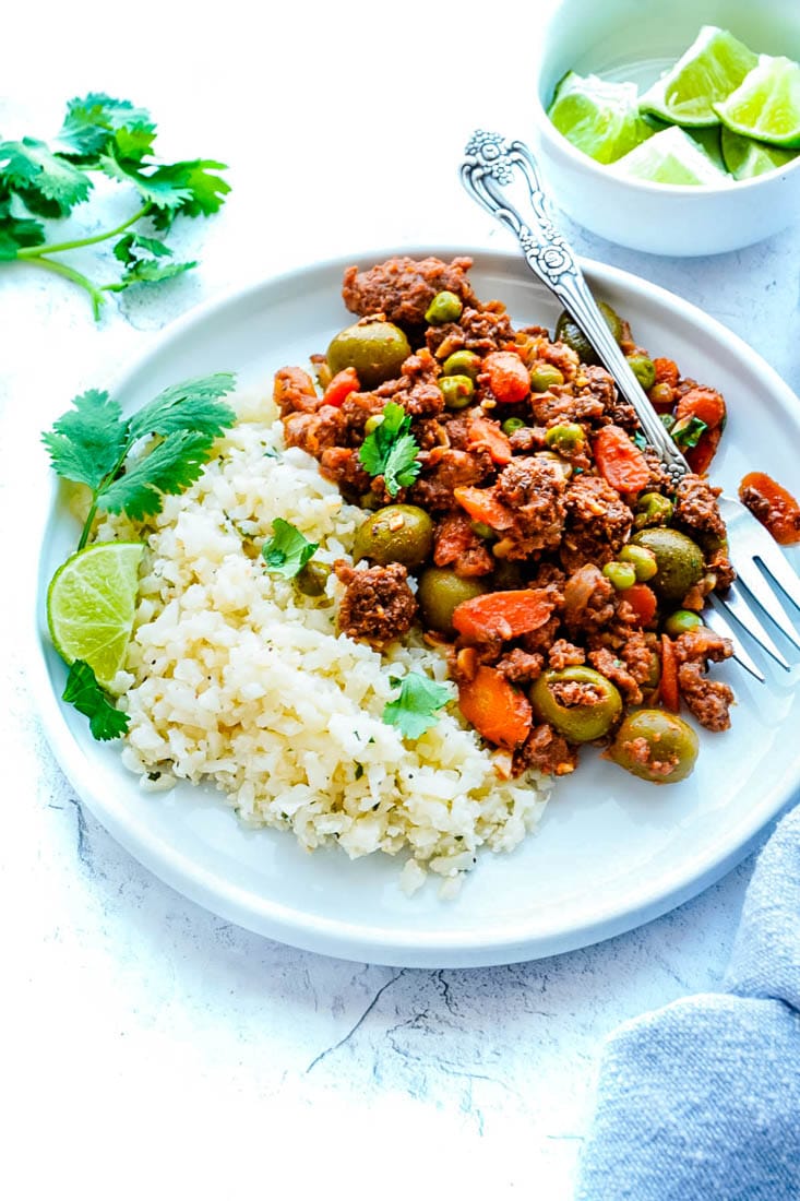 Picadillo on a plate served with rice.