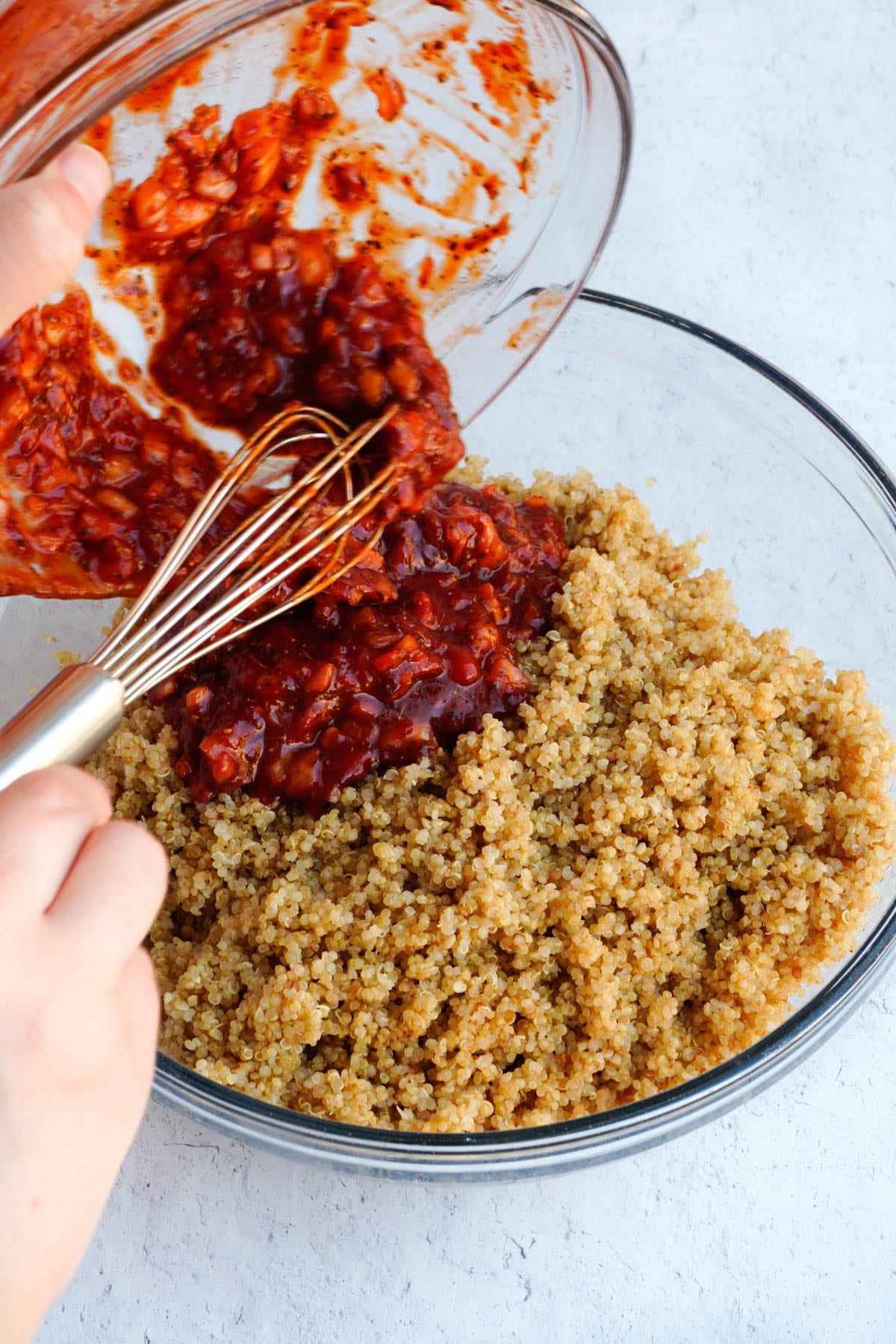 red sauce over a bowl of quinoa