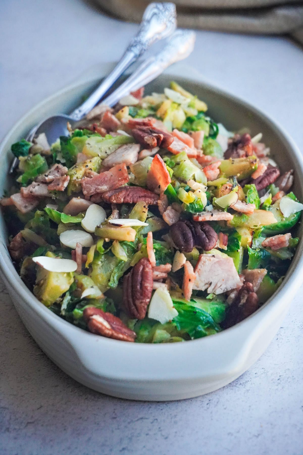 a bowl of Sautéed Brussel Sprouts with pecans and turkey