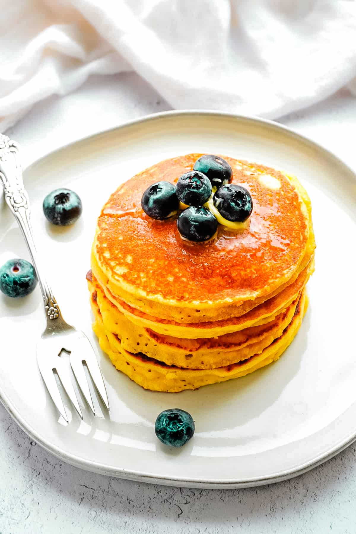 Four Almond Flour Pancakes stacked on top of each other.
