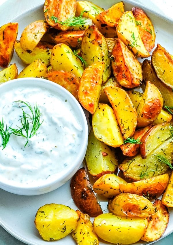 A close up picture of the finished Dill Potatoes on a white platter.