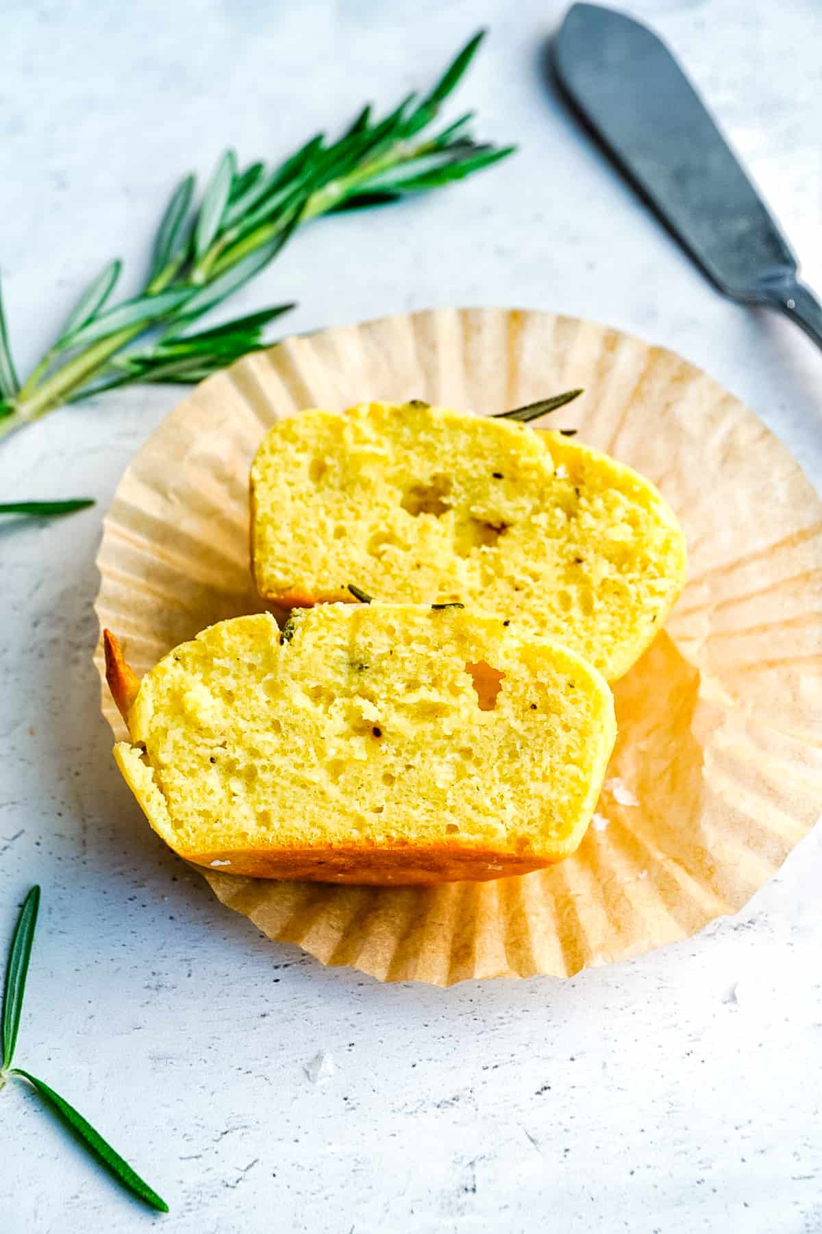 A finished Yogurt Muffins with Rosemary cut in half so you can see what the interior looks like. 