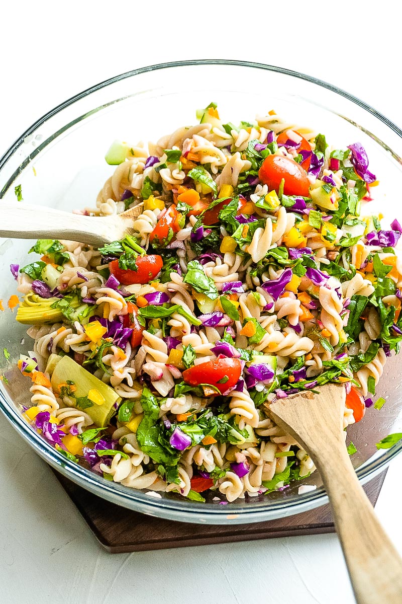 The Gluten Free Pasta Salad tossed together with salad tongs.