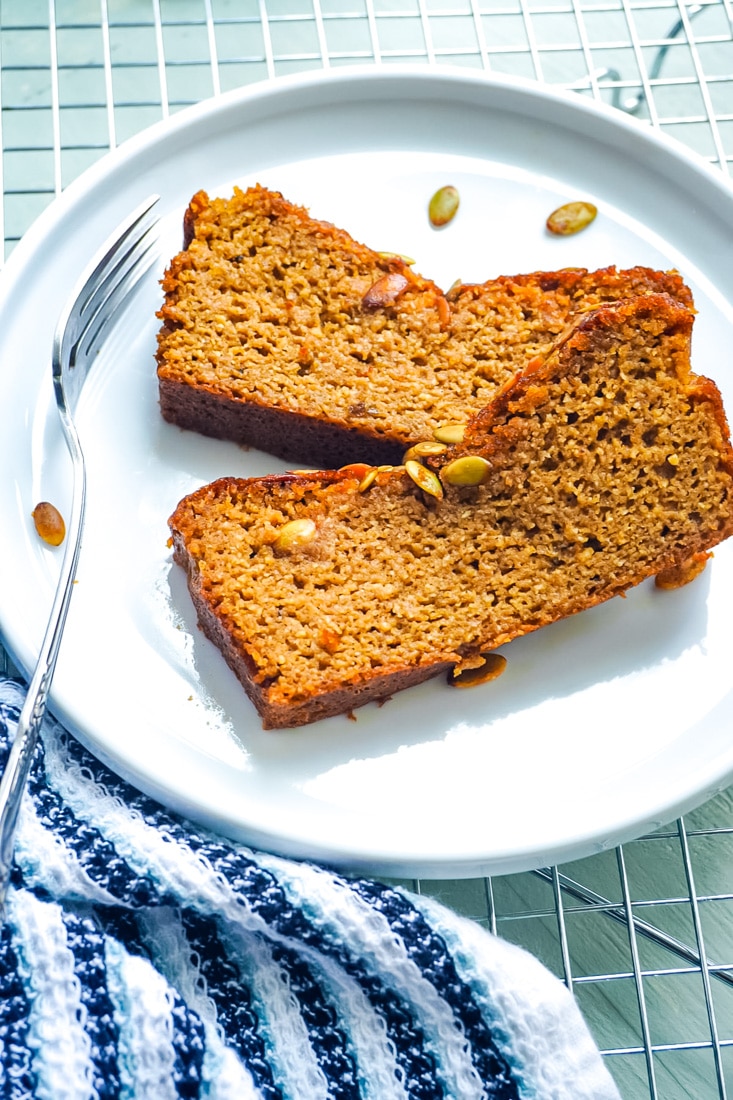 Two slices of Paleo Pumpkin Bread on a white plate.