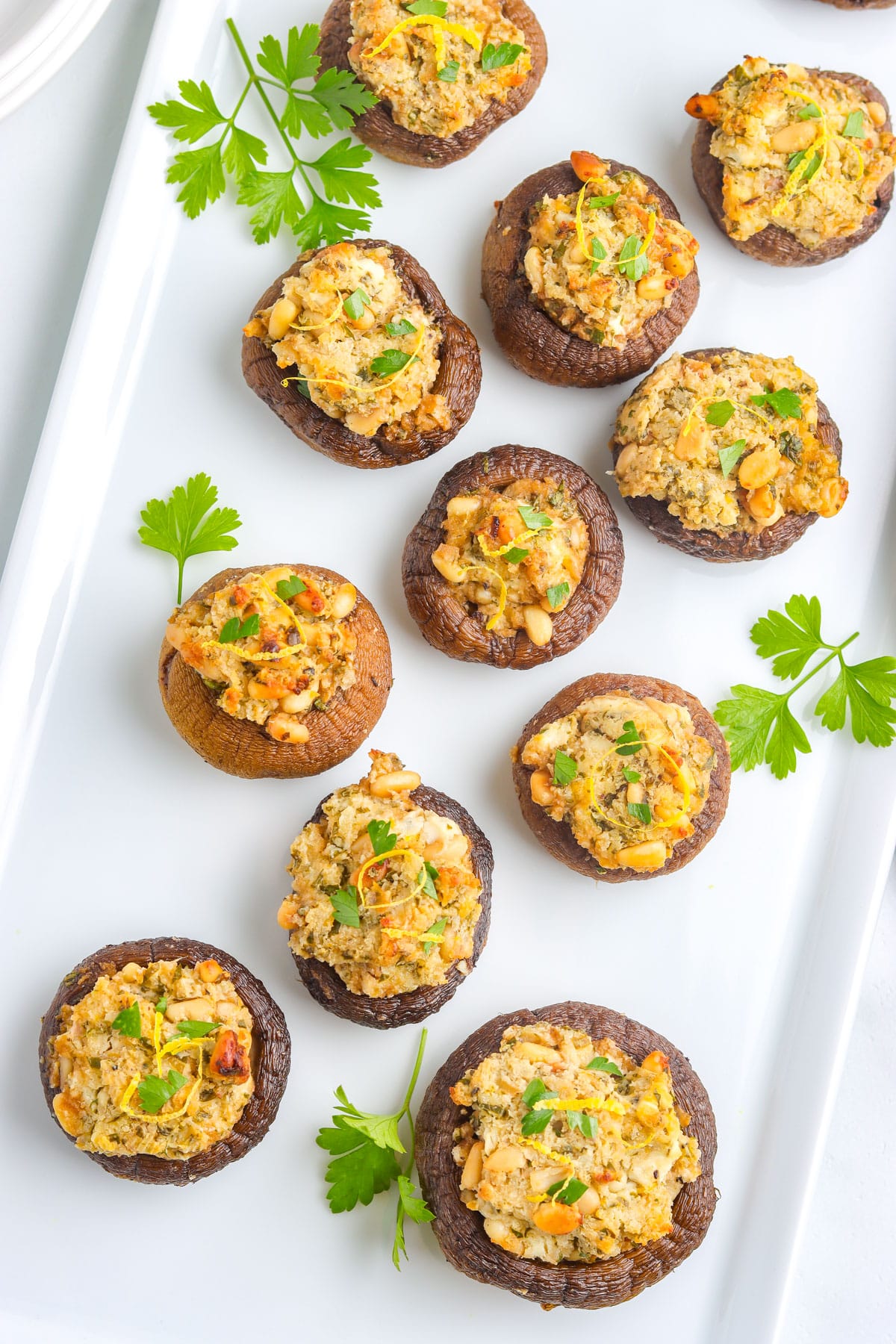 An overhead picture of the finished stuffed mushrooms recipe on a white platter.
