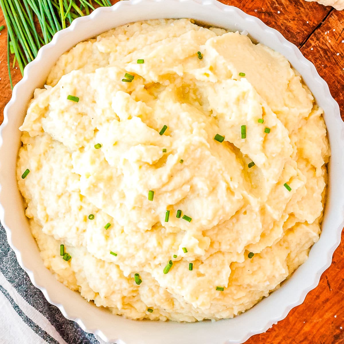 Mashed Cauliflower in a white serving bowl.