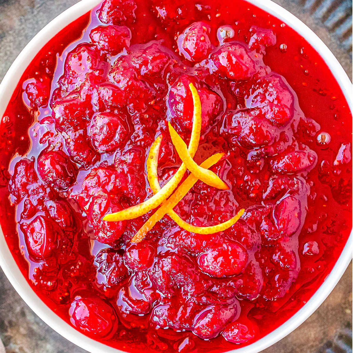 Vegan cranberry sauce in a white serving bowl.