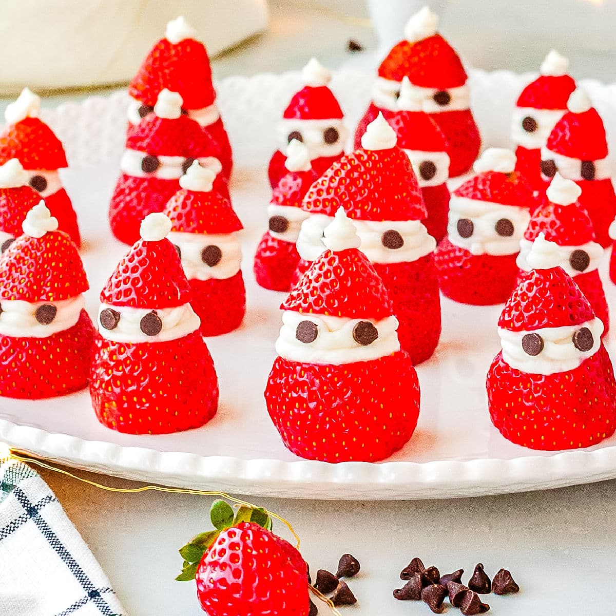 The finished strawberry Santas recipe on a white platter.