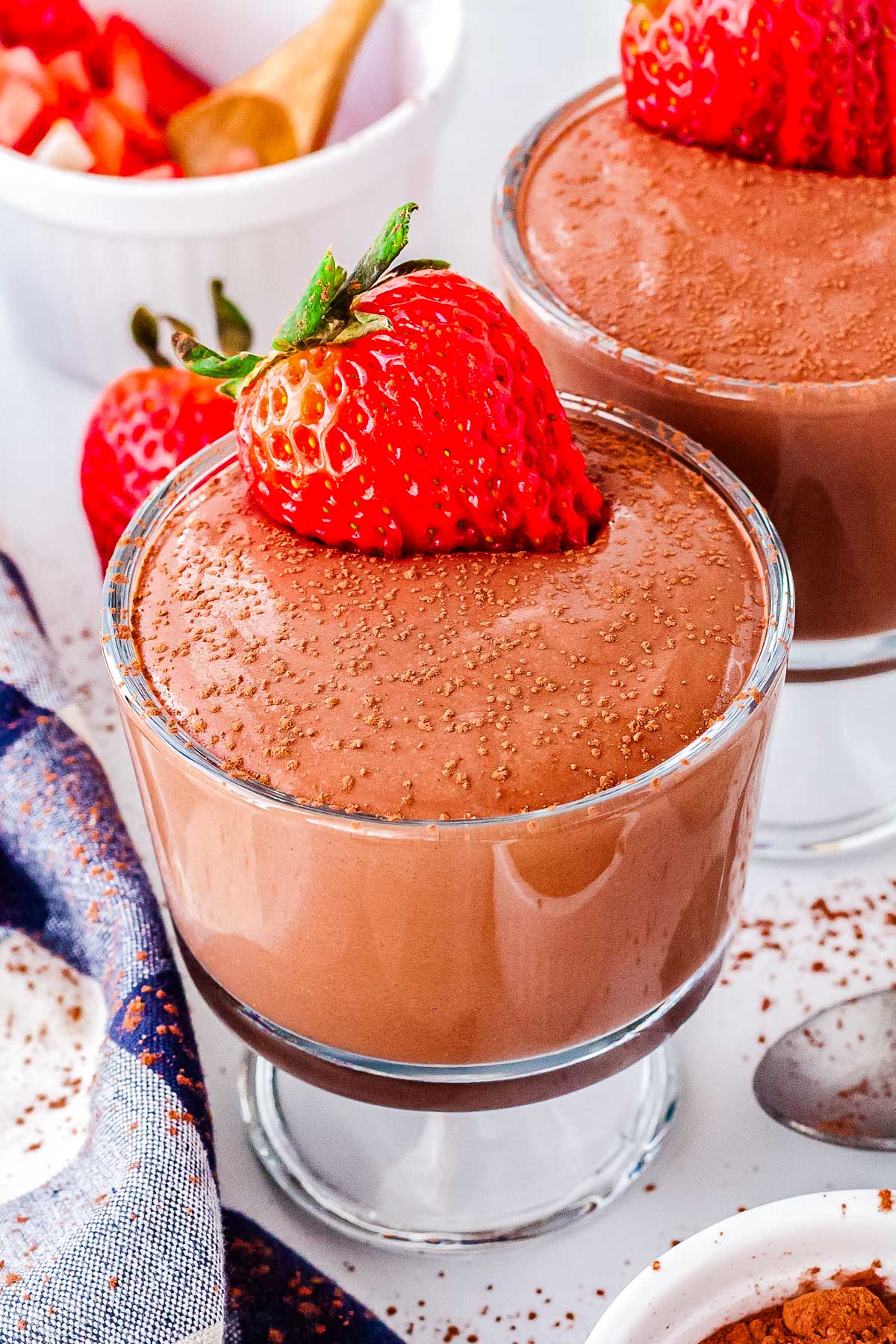 Cottage cheese chocolate mousse topped with a fresh strawberry in a glass cup.